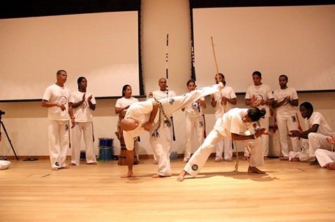 Capoeira students practicing movement and play